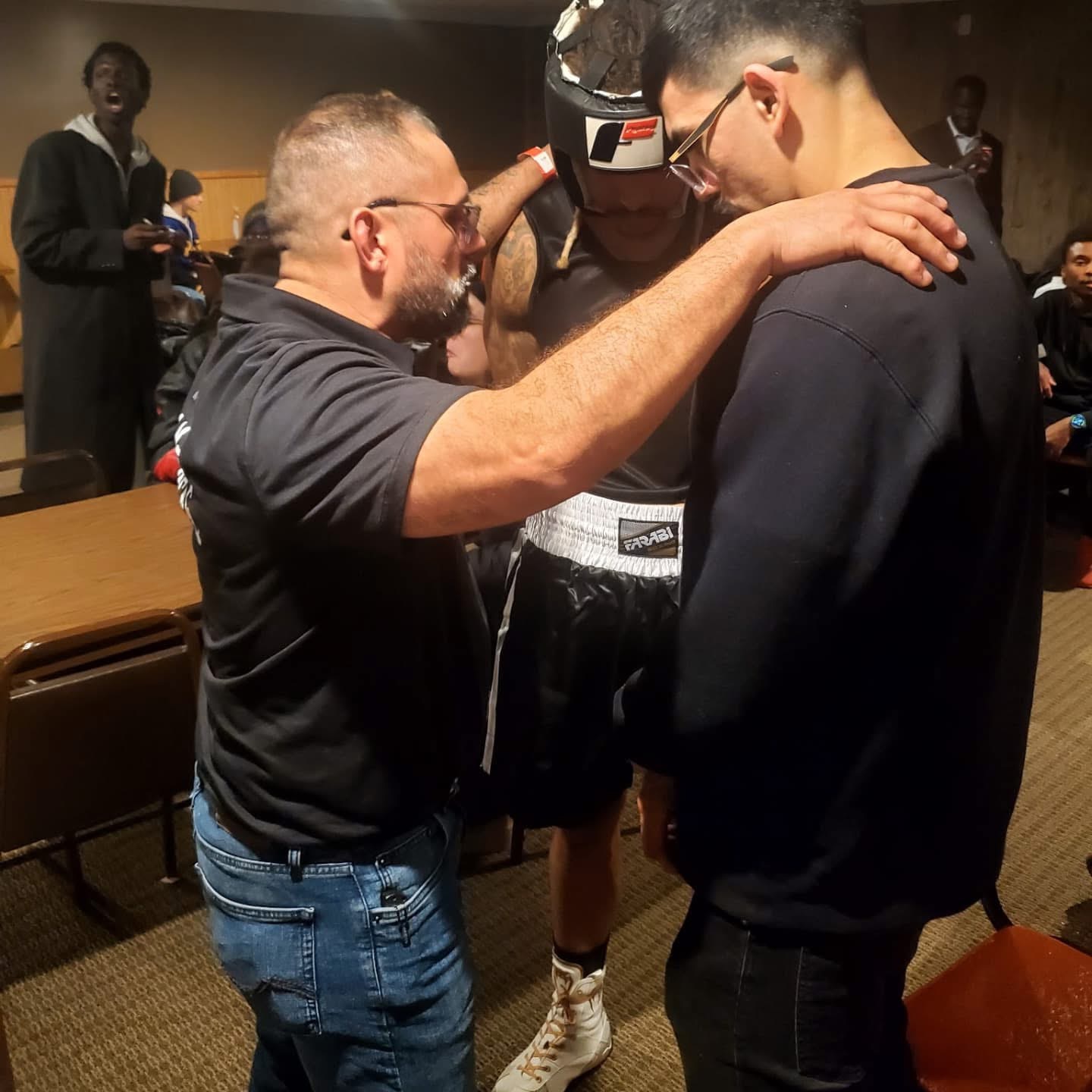 Juan mentoring a young boxer before a fight